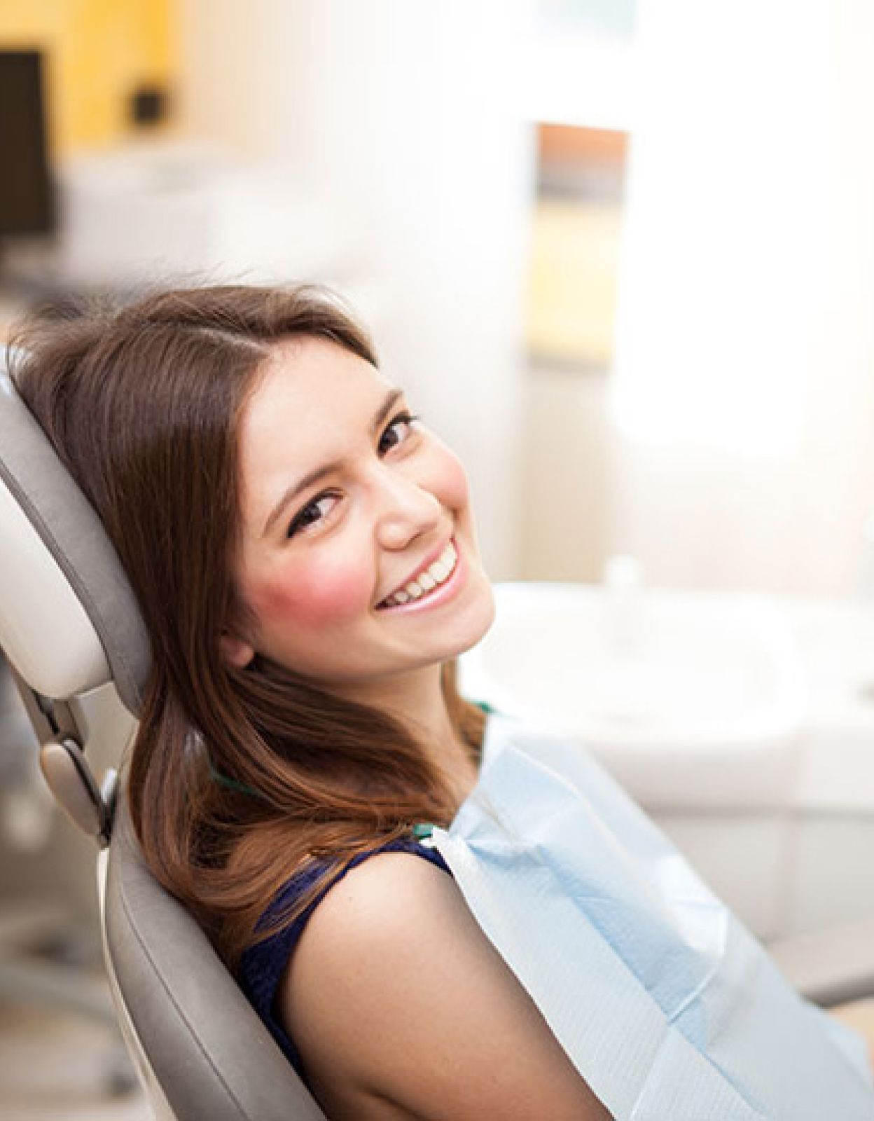 girl smiling sitting in dental office